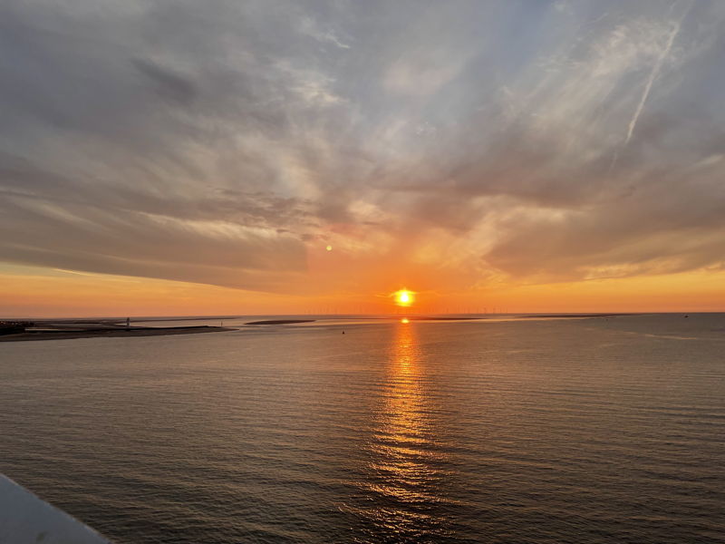 setting sun as cruise ship leaves liverpool mersey bar